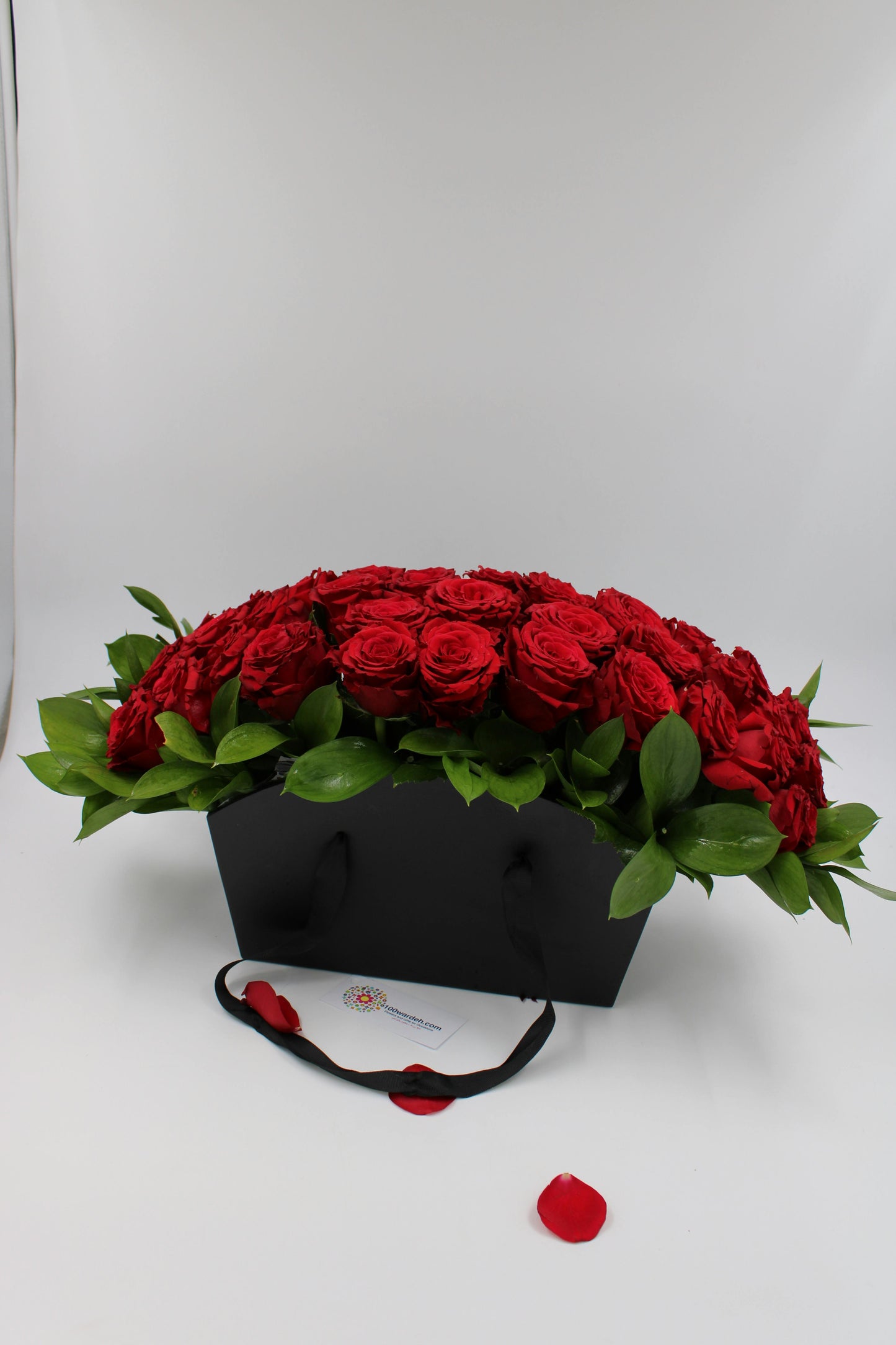 red roses in balck bag